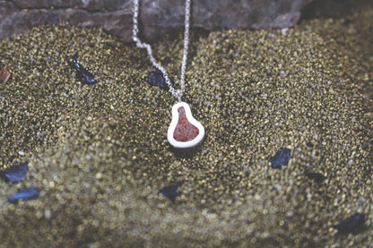 pear shaped silver pendant with Sahara sand inlay