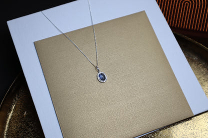 silver necklace with a silver vintage looking pendant with blue moonstone gemstone