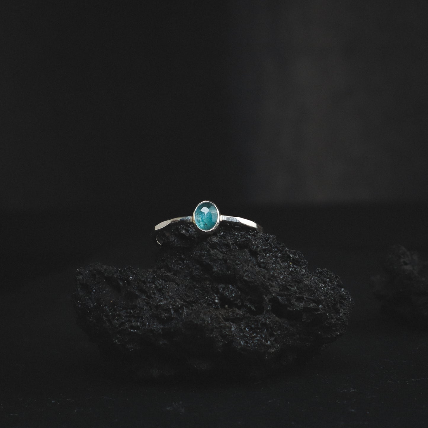 silver ring with light blue toned rose cut gemstone and a textured ring band