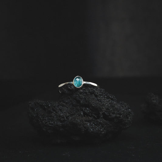 silver ring with light blue toned rose cut gemstone and a textured ring band