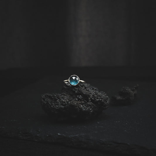 Silver kianite ring on a lava rock.