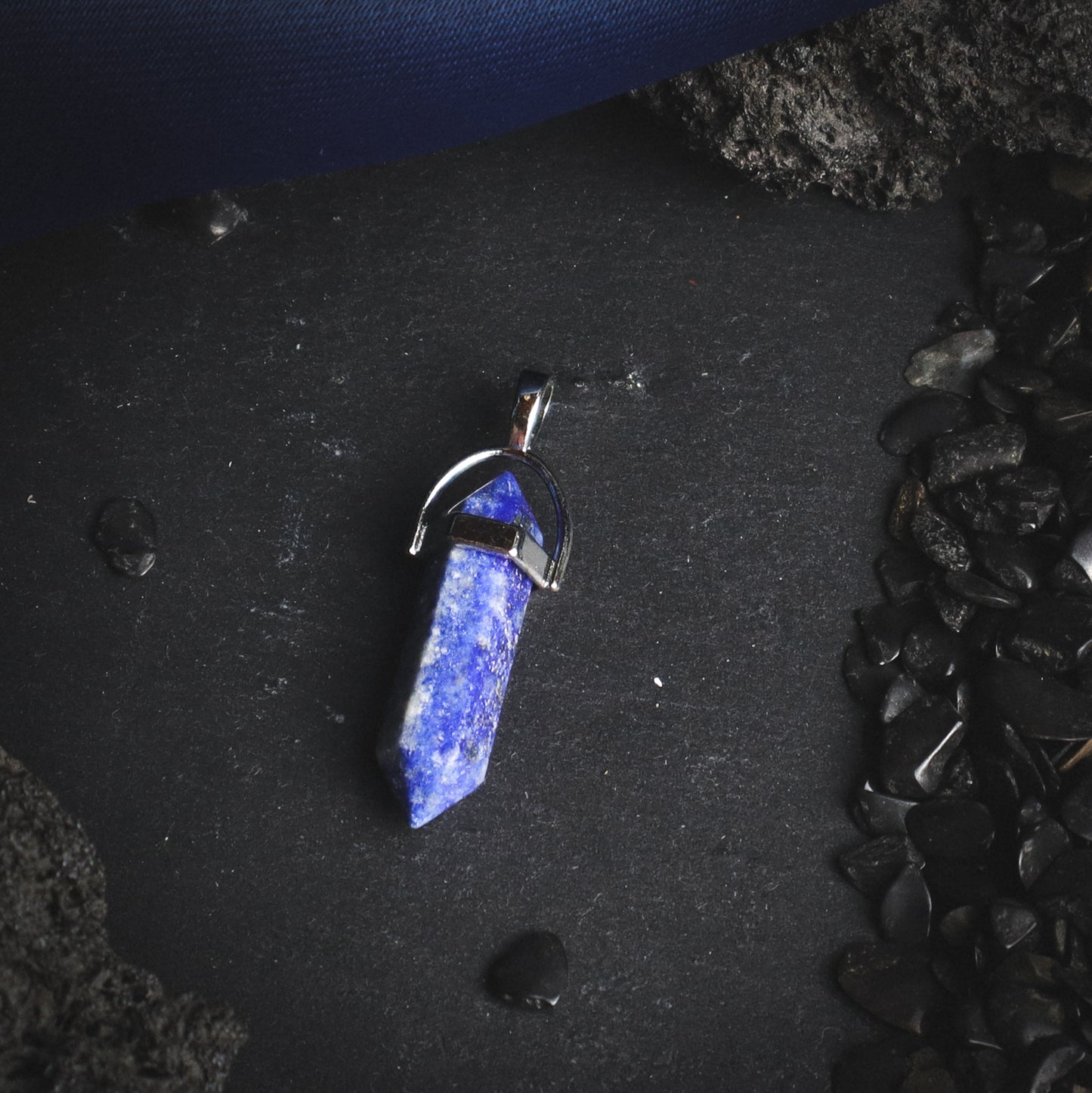 Lapis lazuli mineral pendant with a silver-coloured cap.