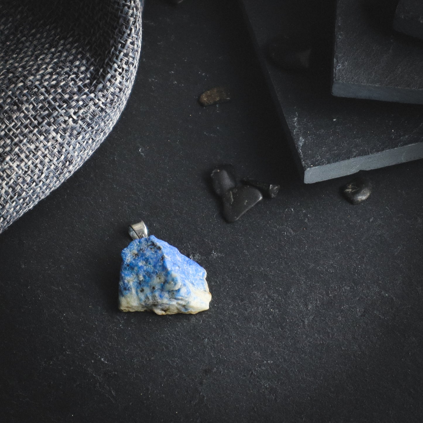 Multicoloured raw mineral pendant.