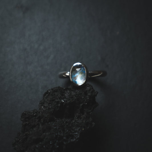 moody silver ring with a blue shine