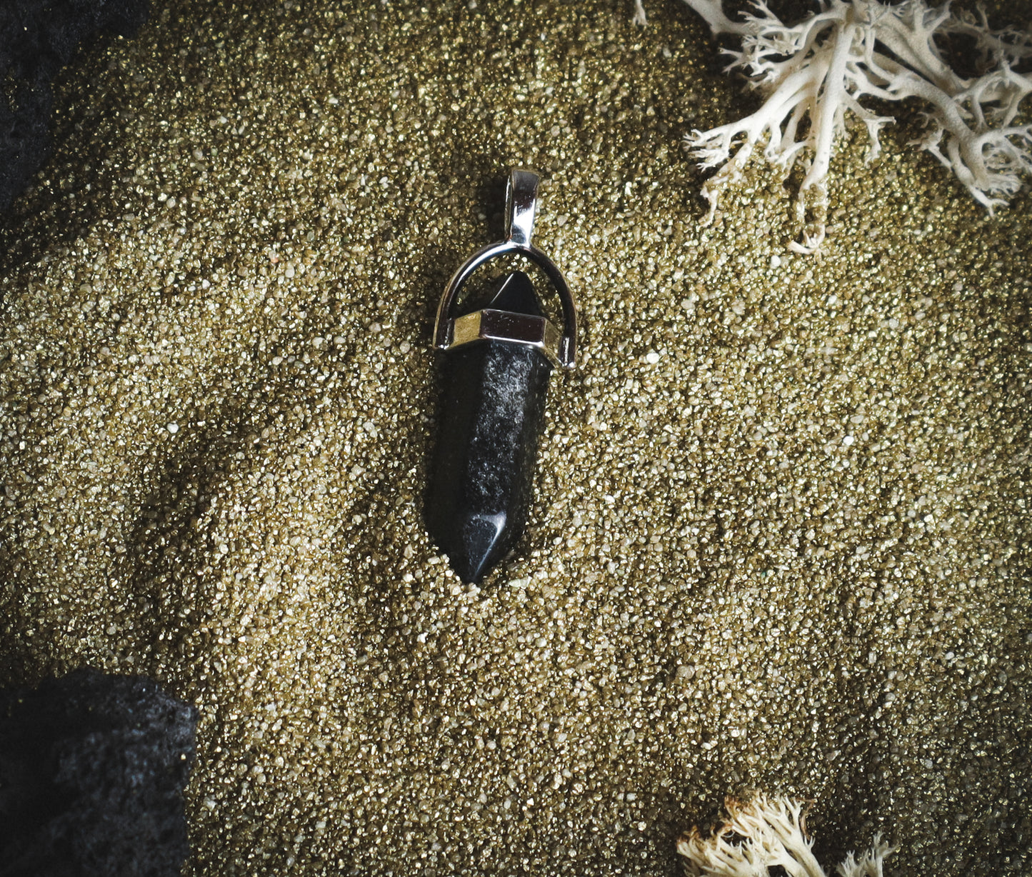 Black pendant with a silver shine.