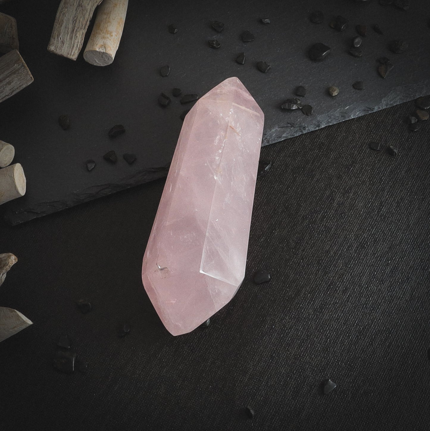 Pink crystal stone on a dark table,