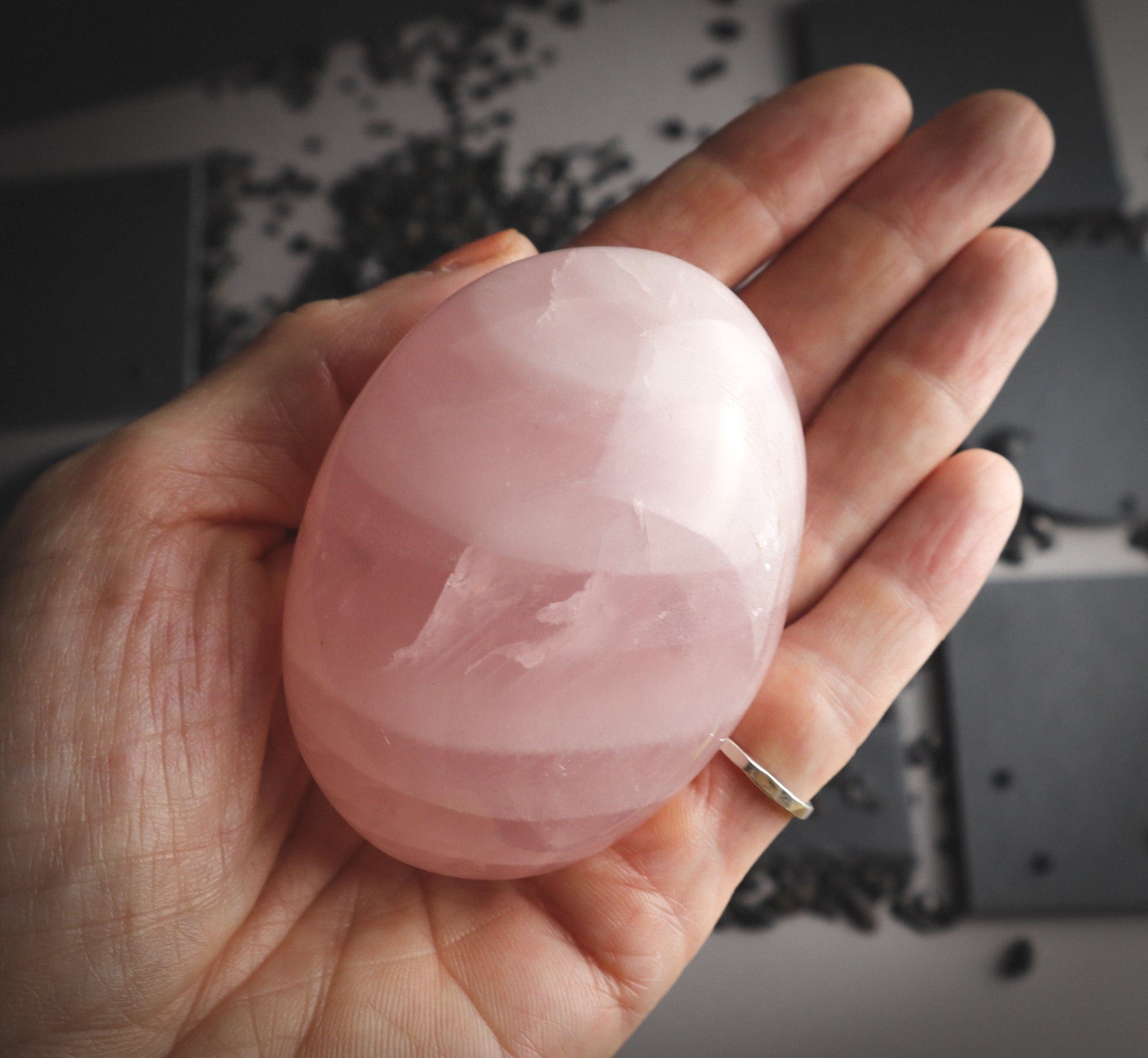 Rose quartz with bands in a hand.