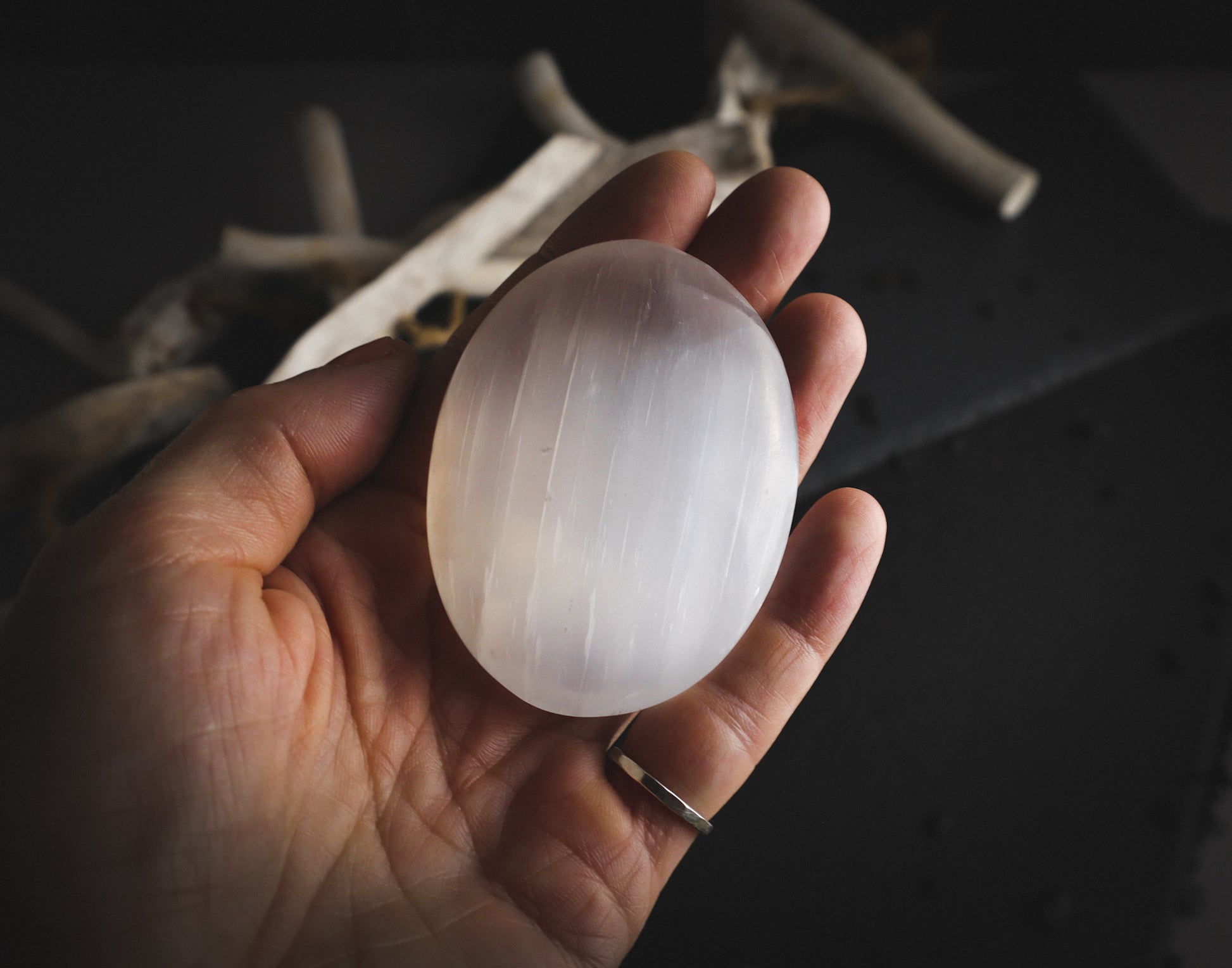 Selenite palmstone in a hand for comparison.