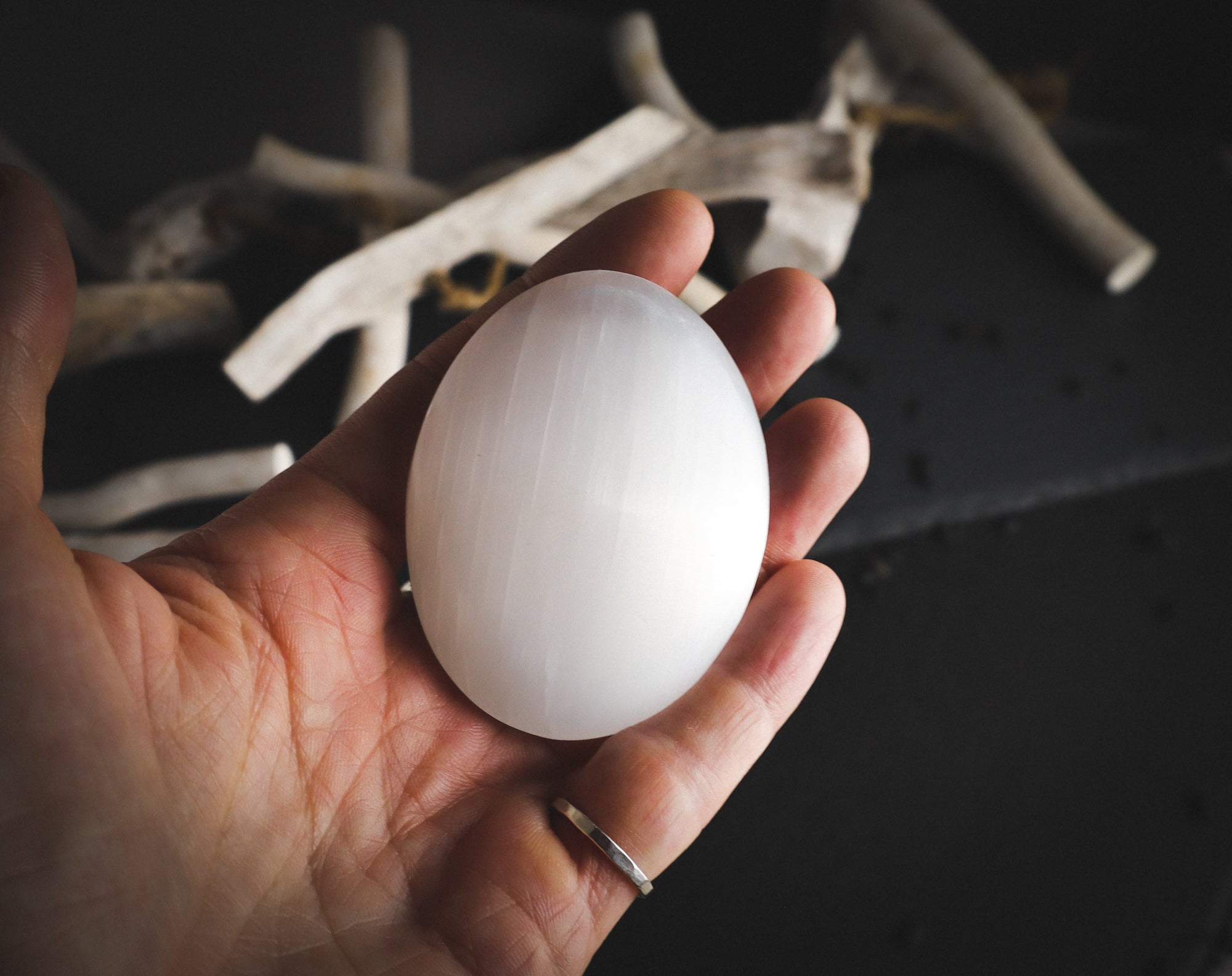 Brilliant white mineral in a hand.