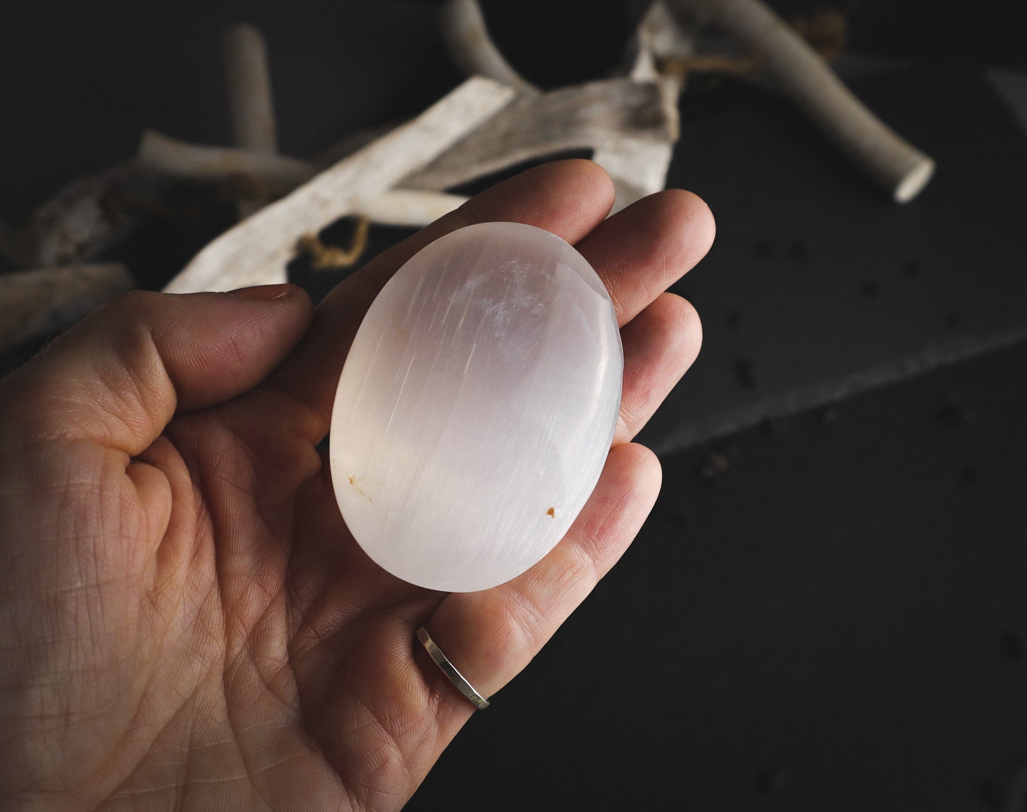 Reflective selenite in a hand.