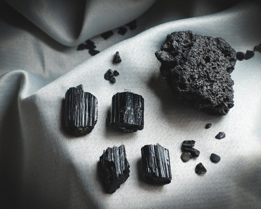 A set of rough black mineral pendants.