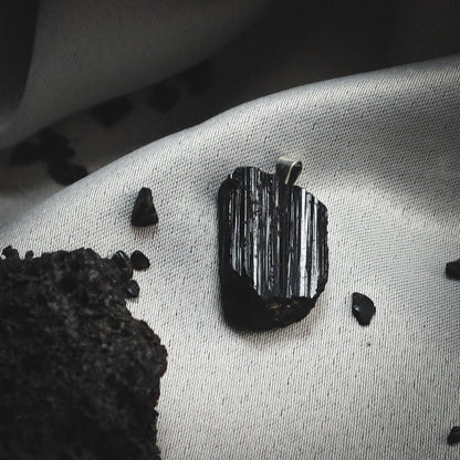 Reflective black rock pendant.